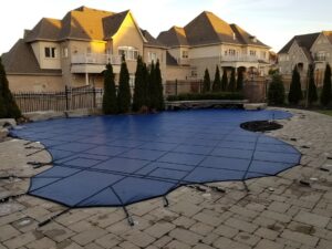 Blue safety cover on a large swimming pool