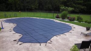 Swimming pool with a blue safety cover