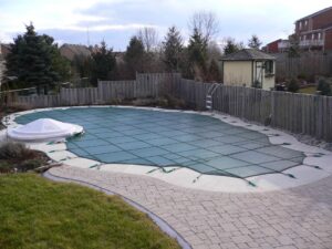 Safety cover on a large oval swimming pool