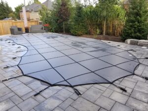 Grey safety cover for swimming pools