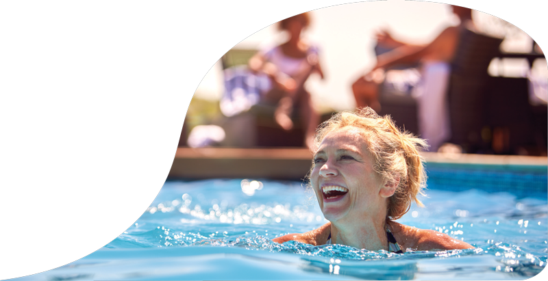Woman smiling while swimming in a pool