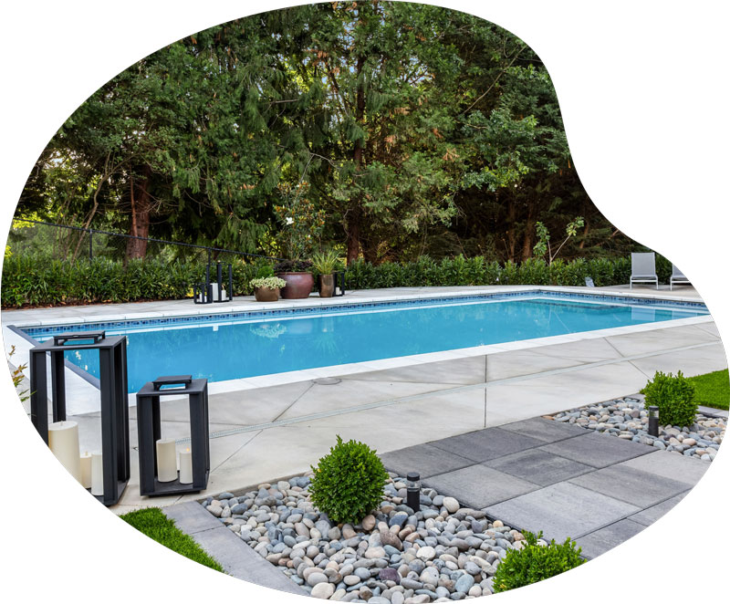 Backyard in-ground pool after weekly pool maintenance.