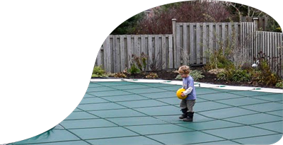 A child plays safely on a covered pool.